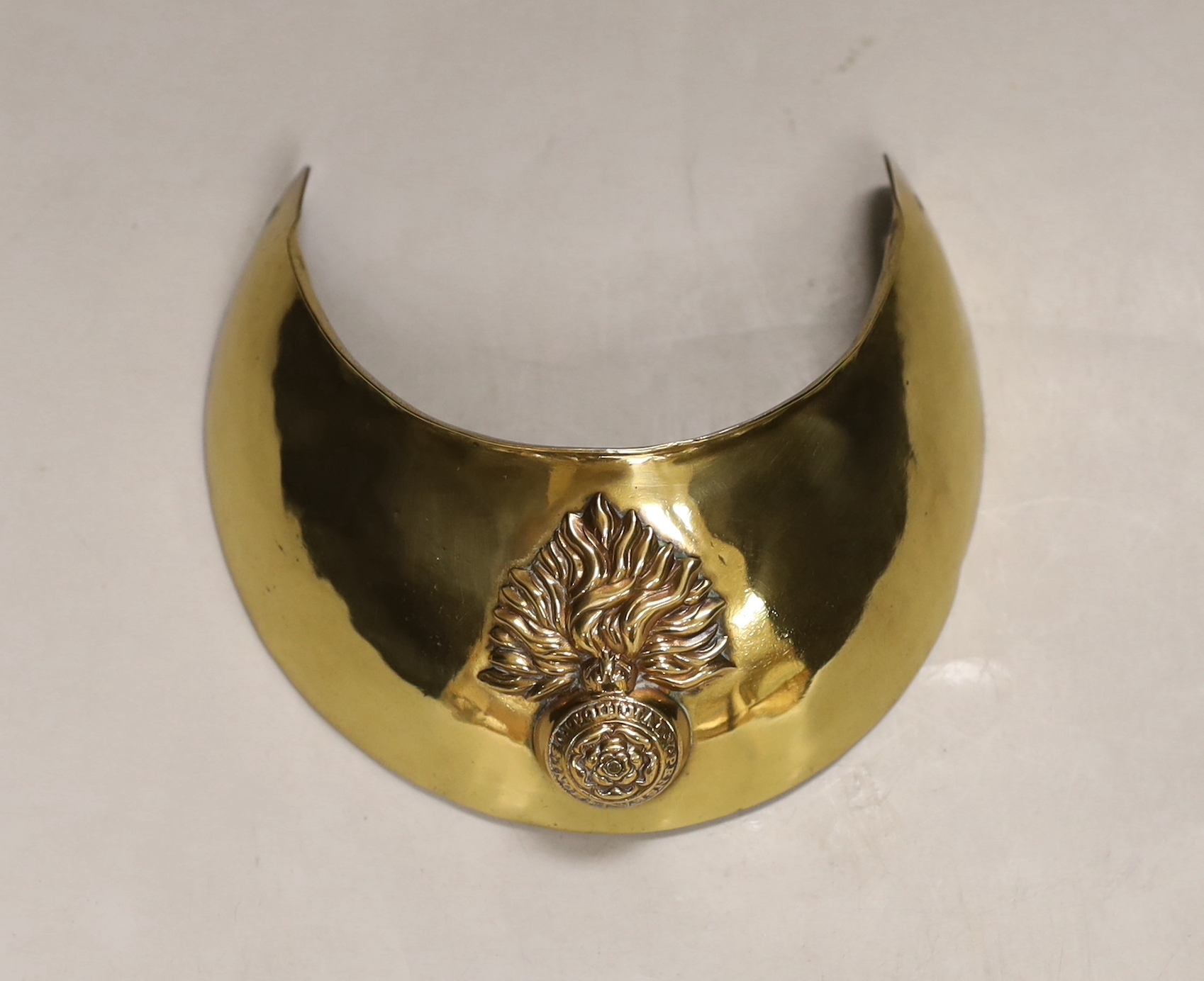 A Royal Fusilliers brass gorget, diameter 12.5cm